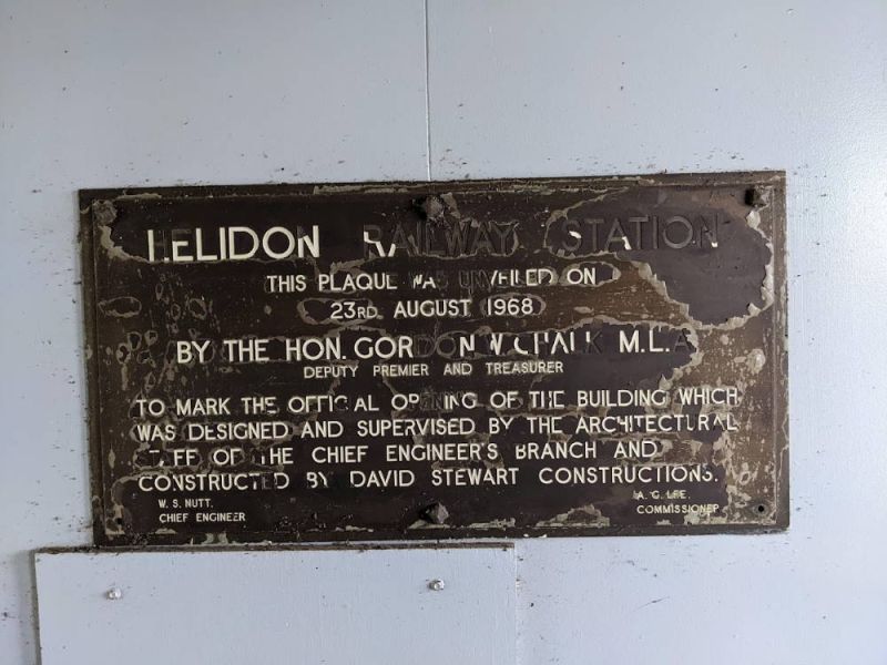 HELIDON RAILWAY STATION
THIS PLAQUE WAS UNVAILED ON
23RD AUGUST 1968

BY THE HON. GORDON W. CHALK M.L.A.
DEPUTY PREMIER AND TREASURER

TO MARK THE OFFICIAL OPENING OF THE BUILDING WHICH
WAS DESIGNED AND SUPERVISED BY THE ARCHITECTURAL
STAFF OF THE CHIEF ENGINEER’S BRANCH AND
CONSTRUCTED BY DAVID STEWART CONSTRUCTIONS.
W.S.NUTT A.C.LEE
CHIEF ENGINEER COMMISSIONER
